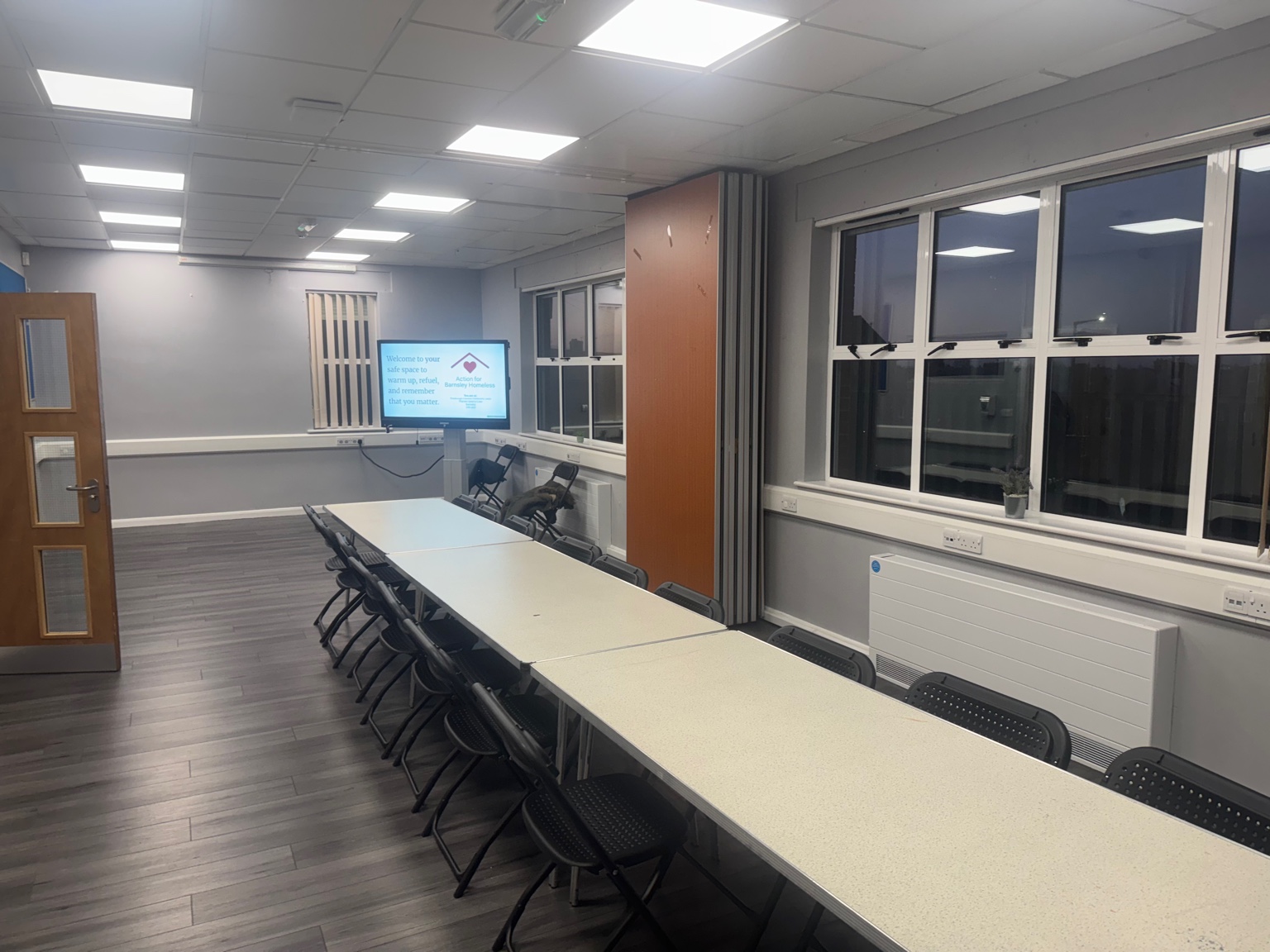 Tables and seating arranged in the community space.